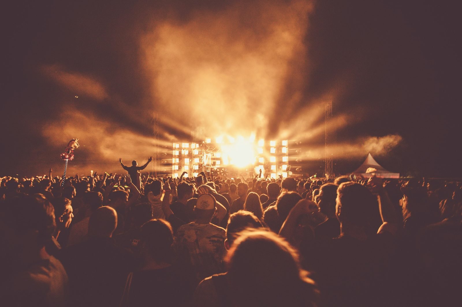 Festival crowd at dusk with stage lights in Finland